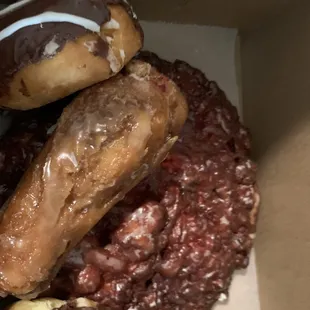 Giant cherry fritter under assortment of bakery items