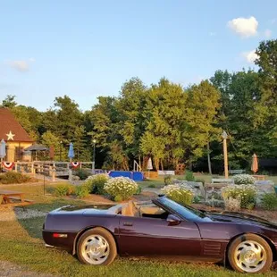 a purple sports car parked in front of a house