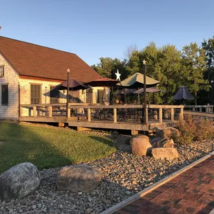 a patio with tables and umbrellas