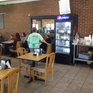 people sitting at tables in a restaurant