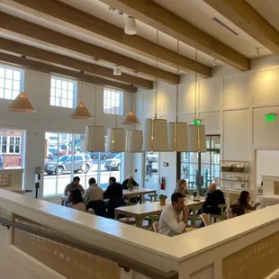 people sitting at tables in a restaurant