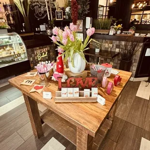 a wooden table with a vase of flowers on it