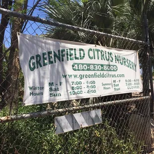 a sign on a chain link fence