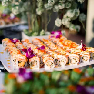 Orange rolls (in: deep friend shrimp, out: salmon, crab meat, spicy mayo, unagi sauce, tobiko).  (Photo by Michelle Chang Photography)