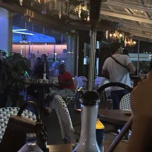 people sitting at tables in a restaurant