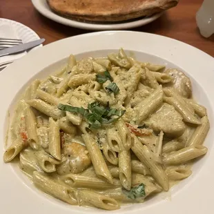 Chicken pesto penne  Italiano Calzone (background)