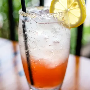 a drink with a lemon slice on the rim