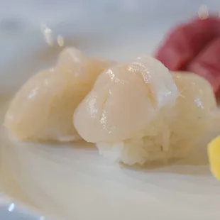 three pieces of sushi on a white plate