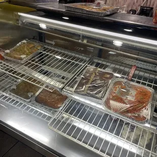 a display case with a variety of pastries