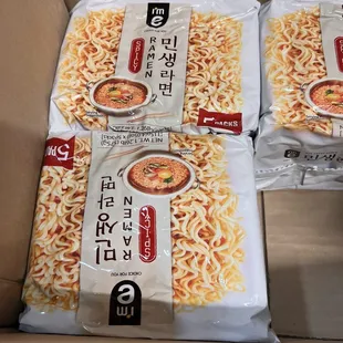 packages of noodles in a cardboard box