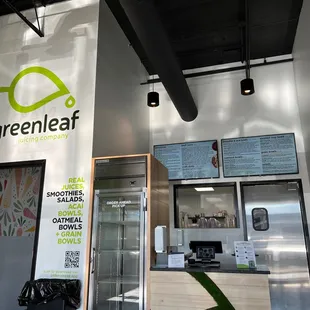 the interior of a green leaf coffee shop