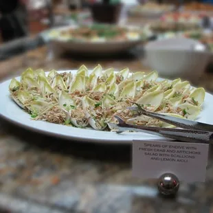Spears of endive with fresh crab and artichoke salad with scallions and lemon aioli