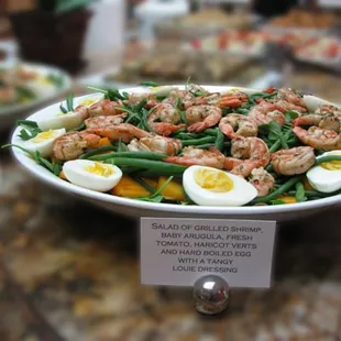 Salad of grilled shrimp, baby arugula, fresh tomato, haricot verts and hard boiled egg with tangy louie dressing