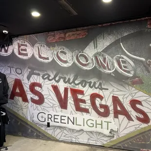 Wall art with some merchandise (hoodies, shirts, etc.)