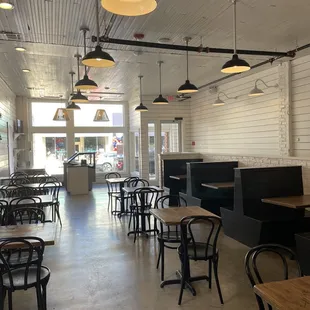the inside of a restaurant with tables and chairs