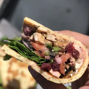 a hand holding a sandwich