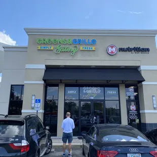 a man standing in front of a restaurant