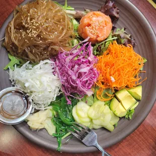 Sweet potato noodle, raw salmon, cucumber, avocado, shredded carrots, red &amp; white cabbage, green salad, seaweed salad, pickled ginger