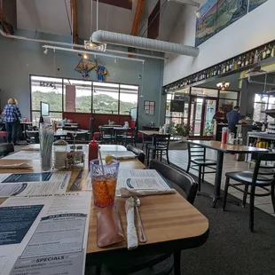 a restaurant with tables, chairs, and menus