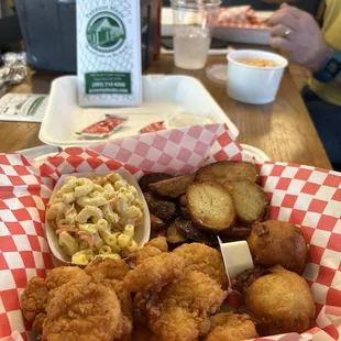 Fried Shimp basket, spiced potatoes, Hawaiian, macaroni, salad, and hush puppies.