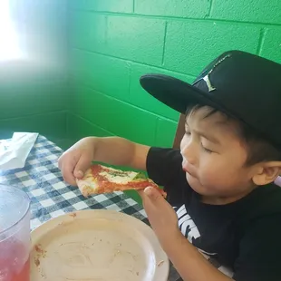 My son enjoying his yummy pizza