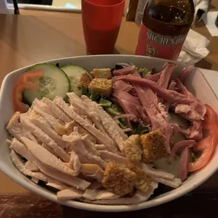 a plate of food and a bottle of beer