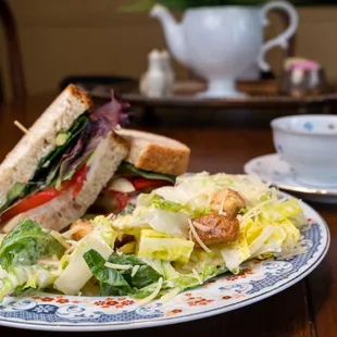 a plate of salad and a sandwich