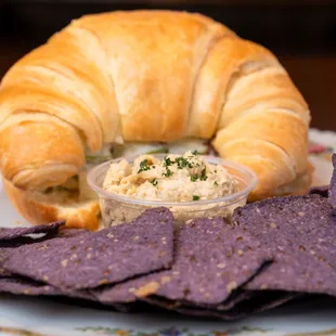 a croissant sandwich and chips