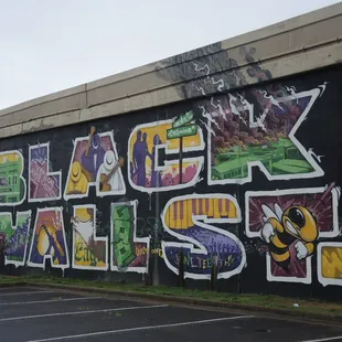 Mural on the freeway wall next to the Greenwood Community Center parking lot