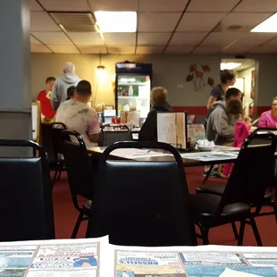 the dining room with people sitting at tables