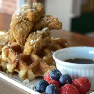 a plate of waffles and berries