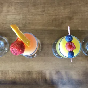 a row of glasses of fruity drinks