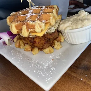chicken egg and cheese waffle sandwich with grits