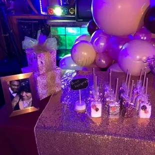 a table with balloons and cake popss