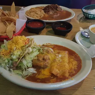 Tostada, rellano &amp; enchilada in the front and huevos rancheros in the back. Chili con queso on the side.