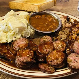 Sampler plate. Brisket, pulled pork and sausage. Potato salad was good but I really don't like the beans