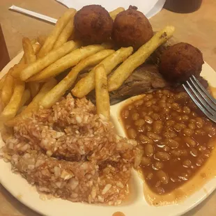 Sliced BBQ pork (under Fries), tasty red slaw and baked beans with hush puppies.