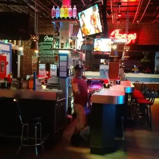 a view of a bar with neon signs