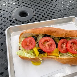 a sandwich with tomatoes and lettuce