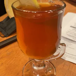 a cup of tea with a lemon wedge