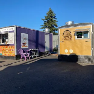 two food trucks parked in a parking lot