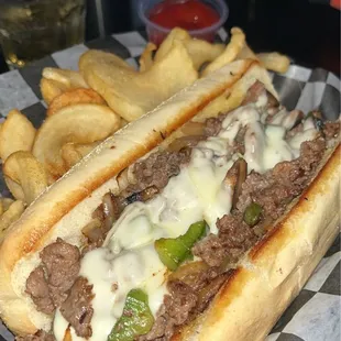 Philly cheesesteaks spiral fries and vodka red Bull in back