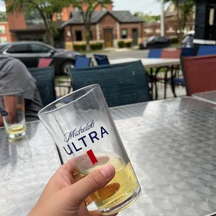 a person holding a beer glass