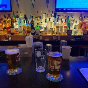 two glasses of beer on the bar