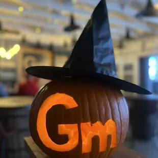 a pumpkin with the word gm carved into it