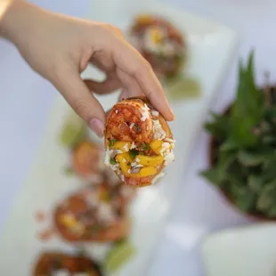 a hand holding a piece of food