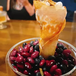 a bowl of cherries and a cone of ice cream