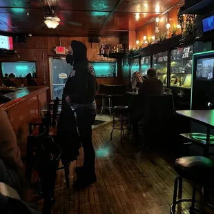 a woman standing in front of a bar