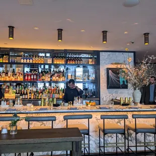 a bar with people behind it