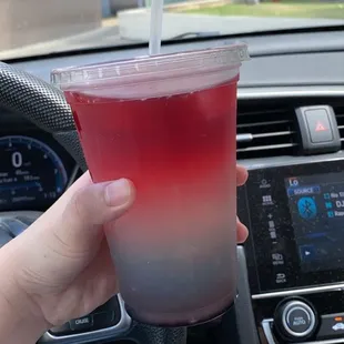 a person holding a drink in a car